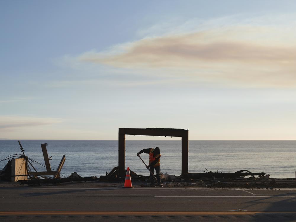 Friday, Jan. 10: A worker clears debris from the Palisades Fire in Malibu.