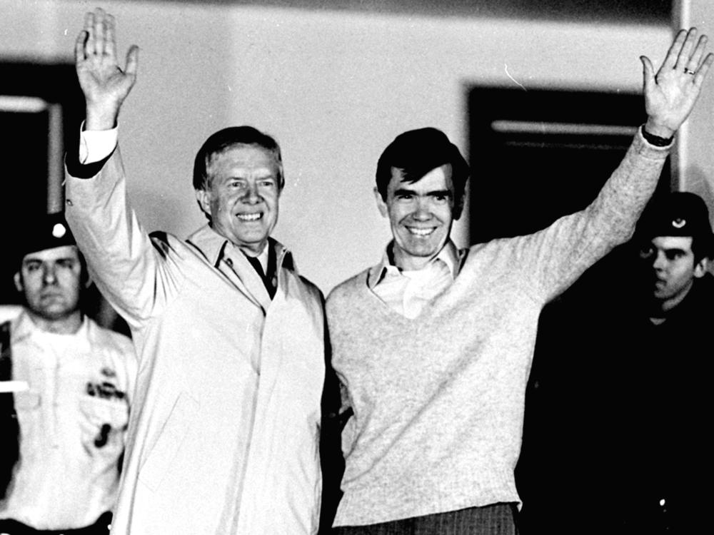 In this Jan. 22, 1981 file photo, former President Jimmy Carter waves with released hostage Bruce Laingen, former chargé d'affaires at the U.S. Embassy in Tehran. Carter, whose presidency had ended two days earlier, paid a visit to the released hostages at the hospital, where they were lodged after being released from 444 days of captivity in Iran.