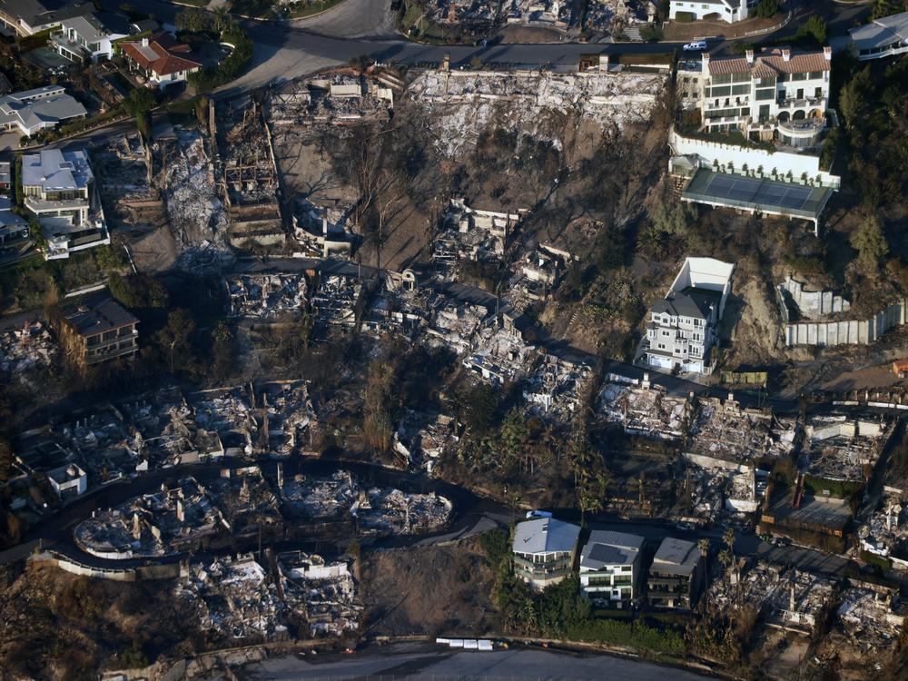 Friday, Jan. 10: This aerial photo shows homes and businesses reduced to smoldering rubble by the Palisades Fire.