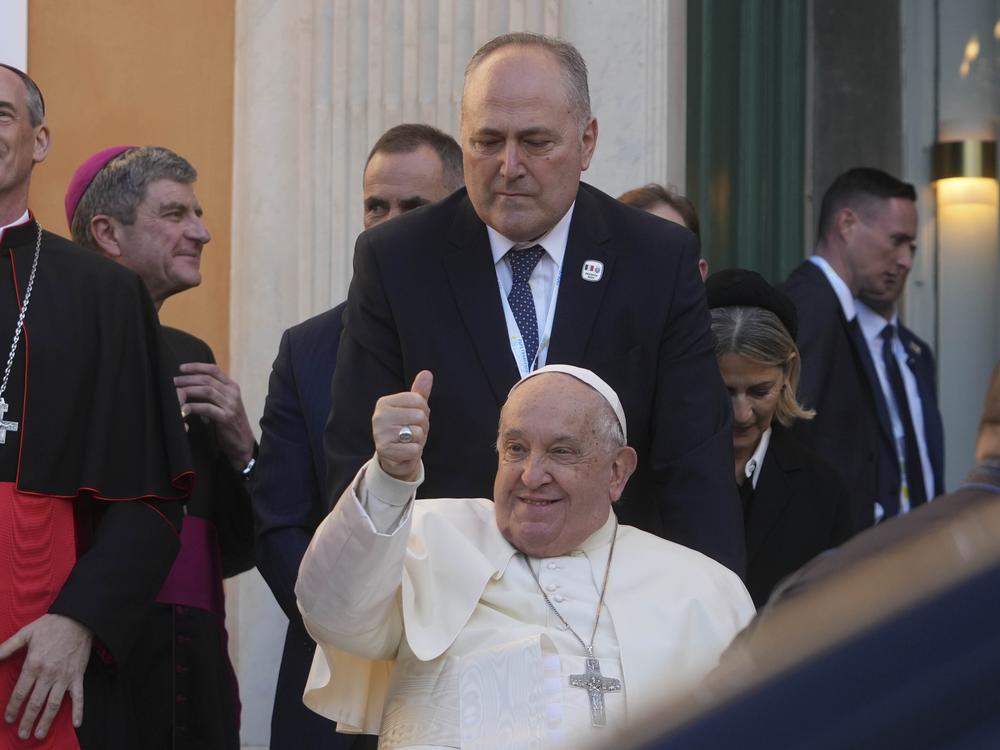 Pope Francis greets faithful during a visit to the French island of Corsica on Dec. 15. President Biden has awarded Pope Francis the Presidential Medal of Freedom with distinction.