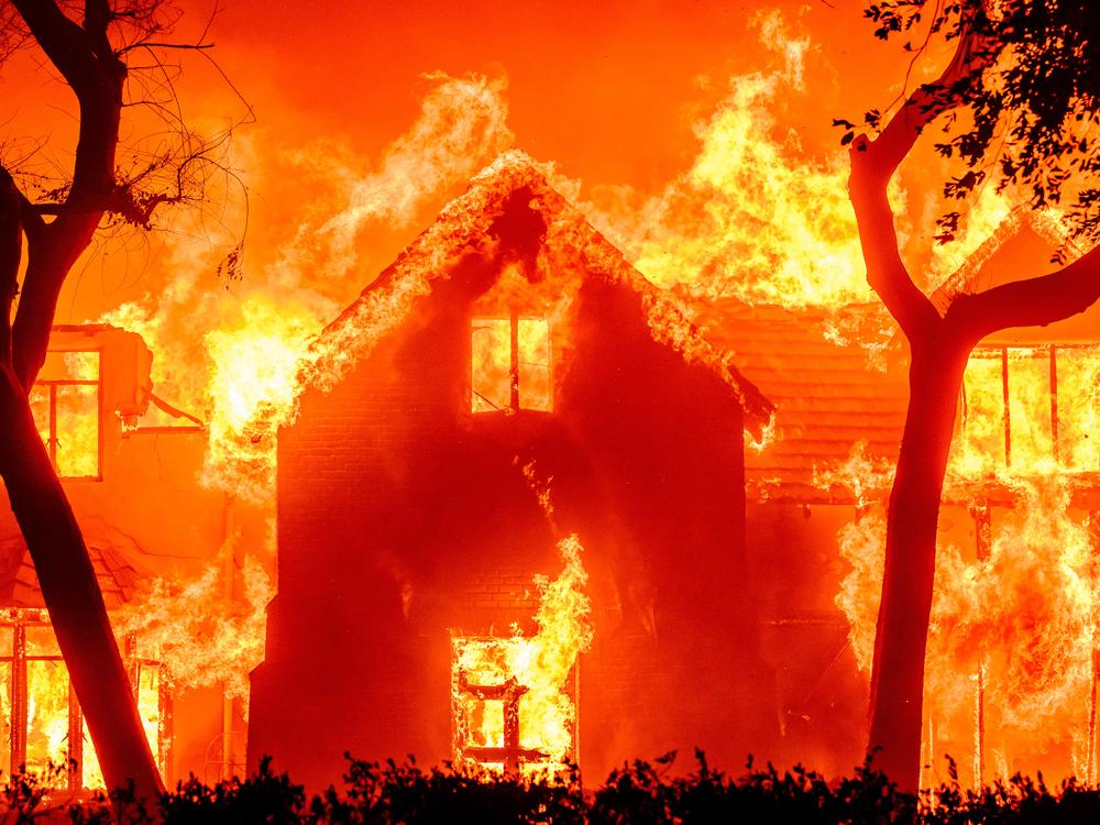 A home is engulfed in flames during the Eaton fire in Southern California in January 2025. Multiple wildfires are raging across the Los Angeles region. Climate change probably made the conditions for those fires more likely.