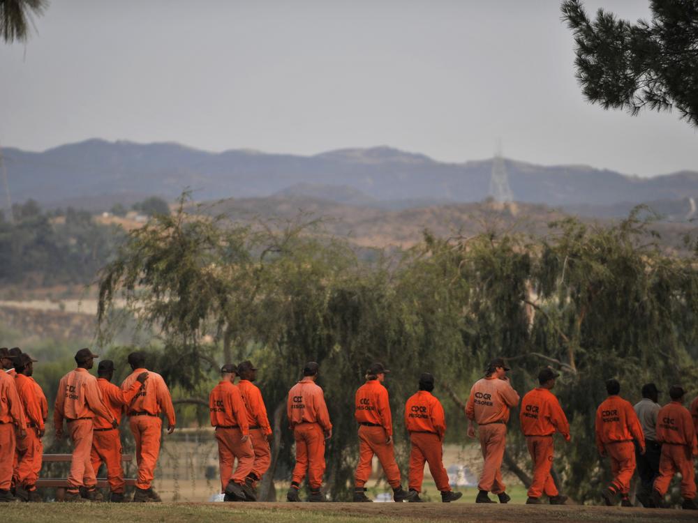 Inmate firefighters from the California Department of Corrections and Rehabilitation walk in at the Station Fire Incident Command Post in the Lake View Terrace area of Los Angeles in 2009.