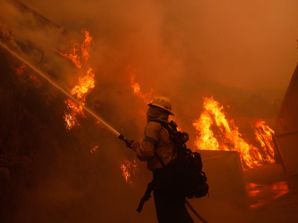 Tuesday, Jan. 7: A firefighter battles the advancing Palisades Fire in the Pacific Palisades neighborhood of Los Angeles.