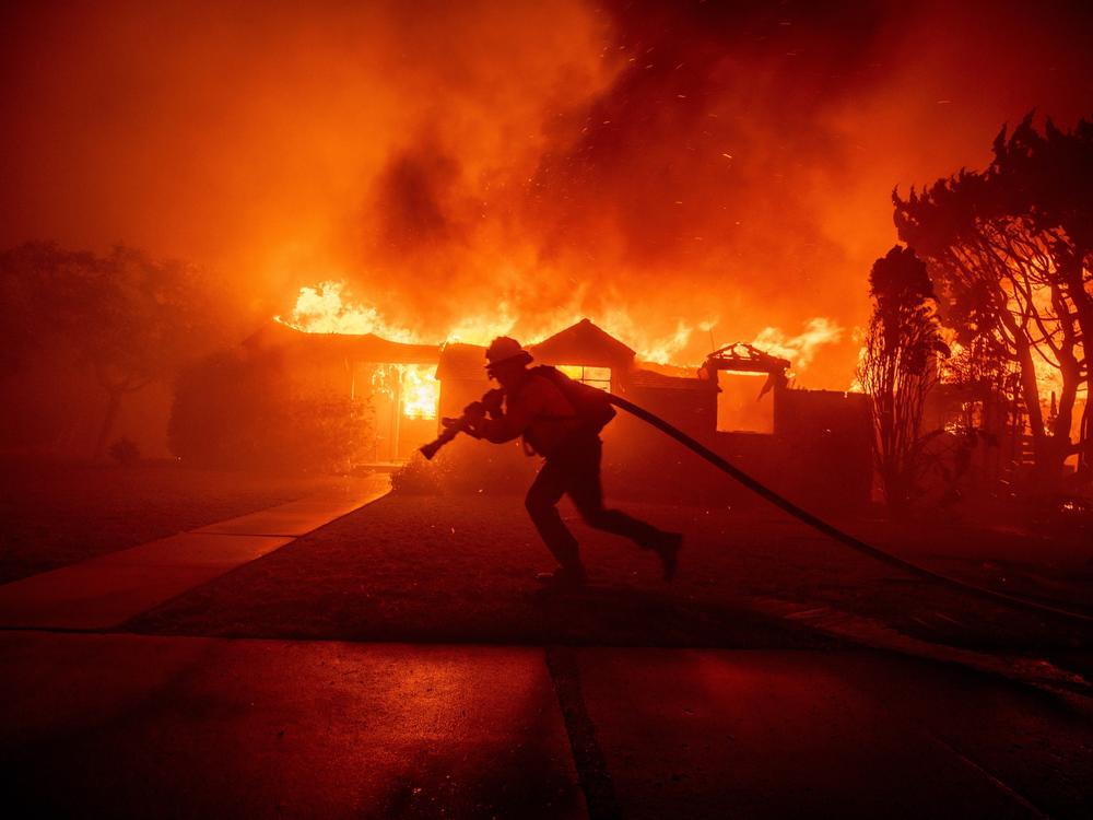 Tuesday, Jan. 7: A firefighter battles the Palisades Fire.