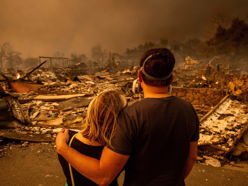 Wednesday, Jan. 8: Megan Mantia, left, and her boyfriend, Thomas, return to Mantia's fire-damaged home after the Eaton Fire swept through Altadena, Calif.