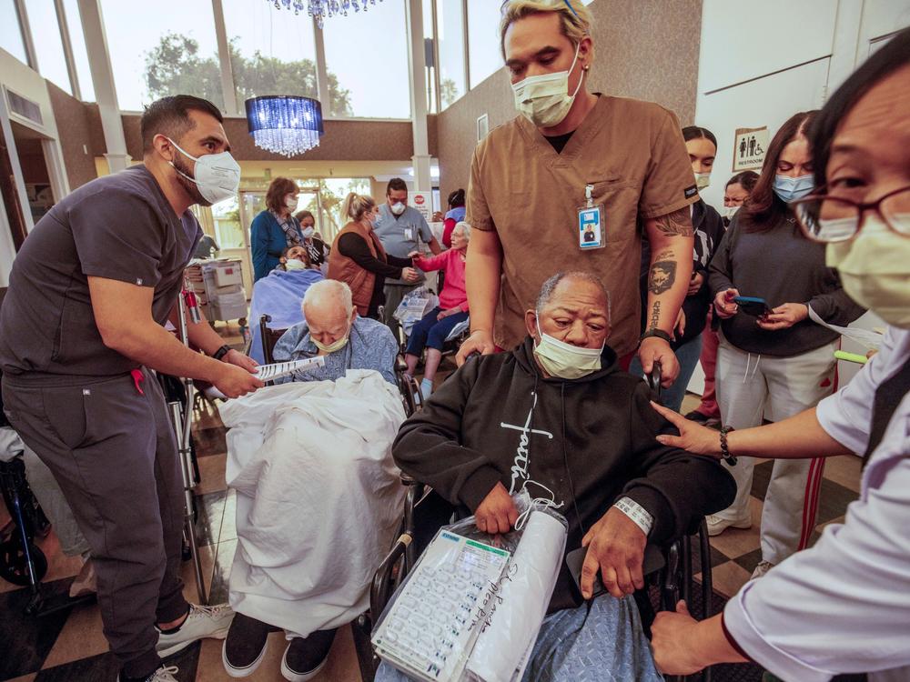 Wednesday, Jan. 8: Residents are evacuated from a senior living facility as the Eaton Fire approaches Altadena, Calif.