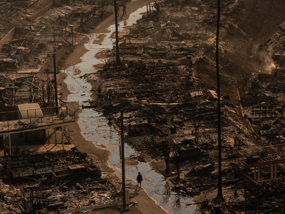 Thursday, Jan. 9: A person walks amid the destruction left by the Palisades Fire in the Pacific Palisades neighborhood of Los Angeles.