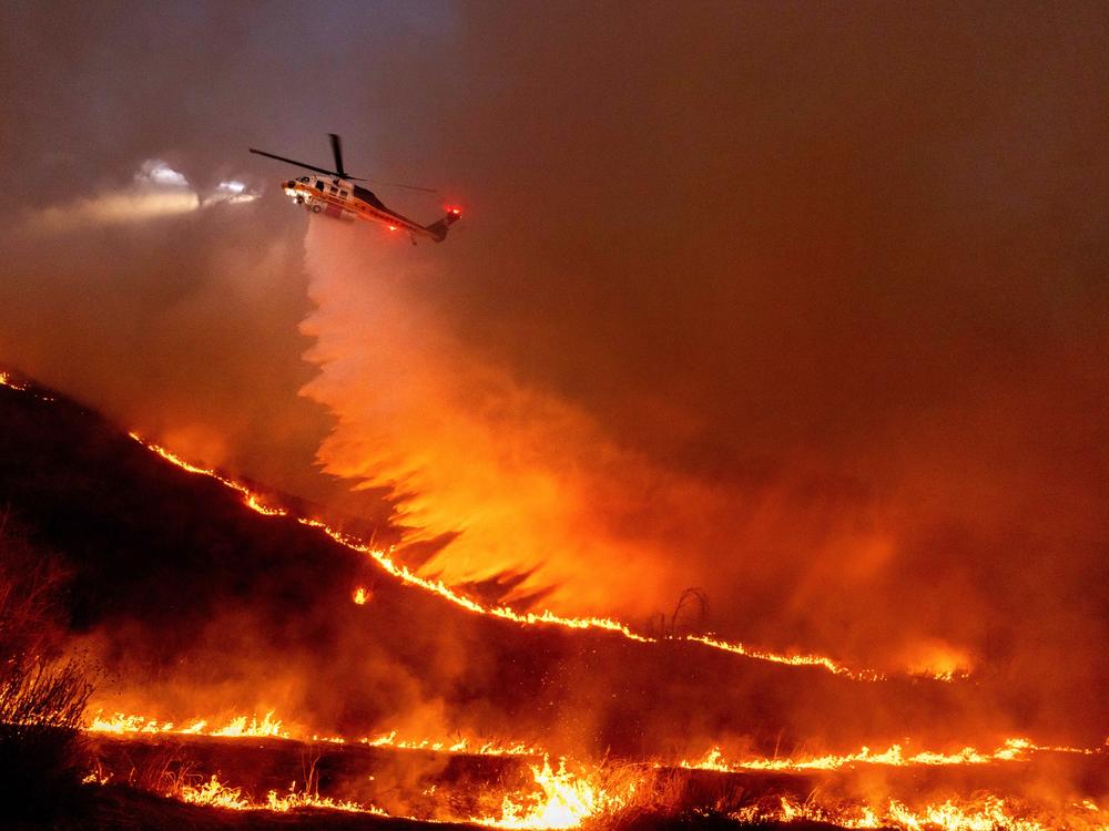 Thursday, Jan. 9: Water is dropped by helicopter on the Kenneth Fire in the West Hills section of Los Angeles.