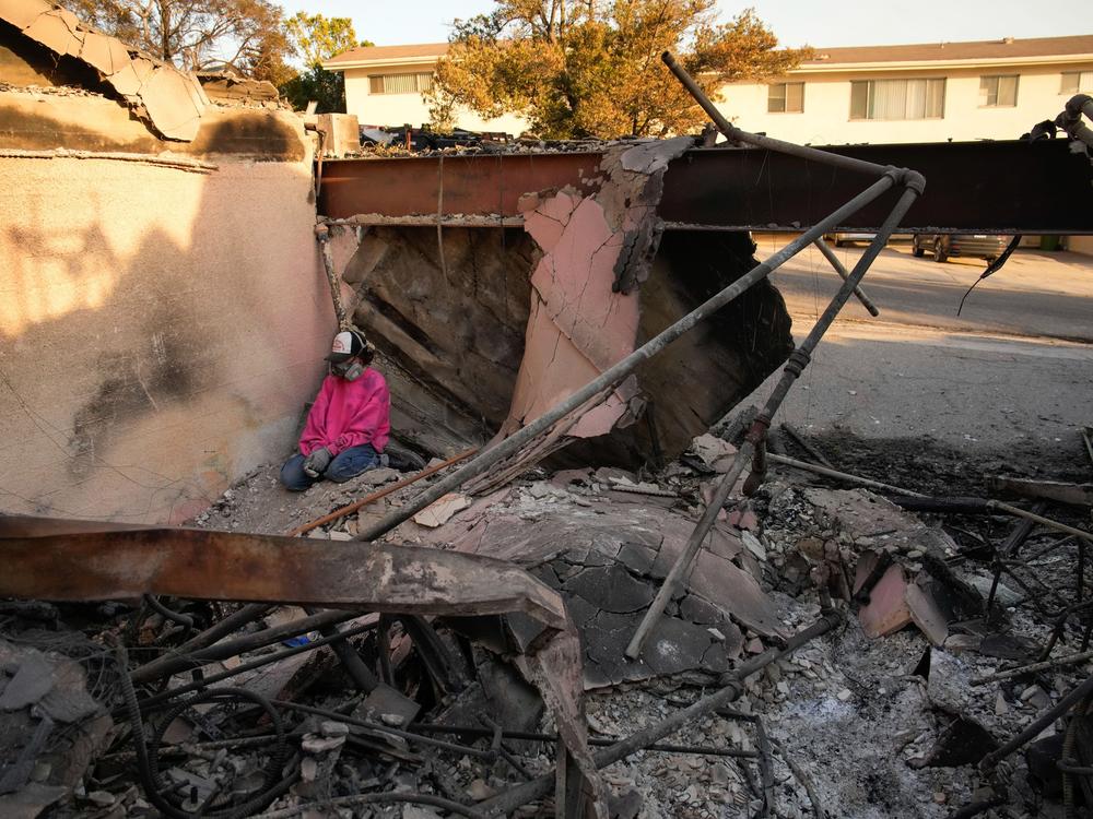 Saturday, Jan. 11: Kaegan Baron sits amid the rubble of her mother's home, which was destroyed by the Palisades Fire in the Pacific Palisades neighborhood of Los Angeles.