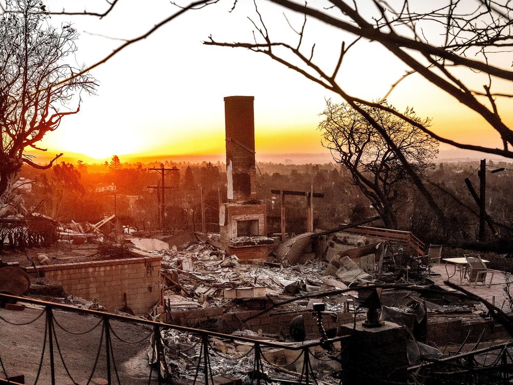 Sunday, Jan. 12: The sun rises behind a home destroyed by the Palisades Fire in the Pacific Palisades community of Los Angeles.