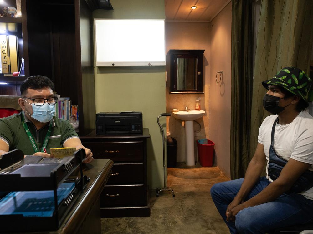 Dr. Cesár Gantes, a Panama Health Ministry physician who has worked with the indigenous groups since the 1990s and founded , meets with a patient. He is the founder of a clinic that provides antiretroviral medications.