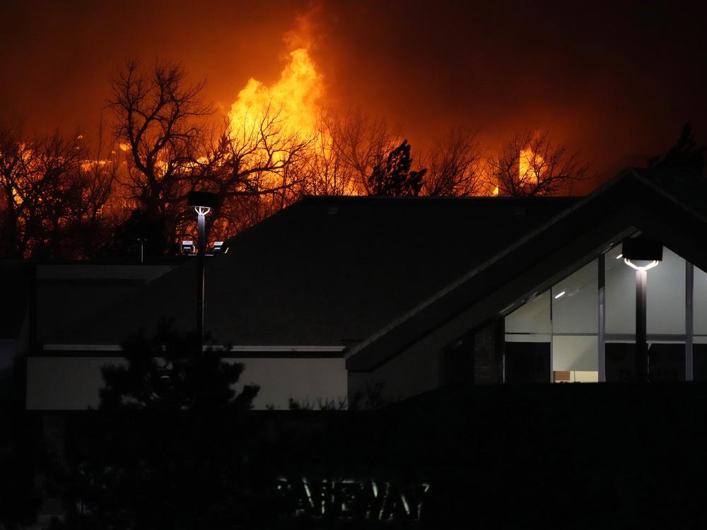 Flames explode as wildfires burn near a shopping center near Broomfield, Colo., on Dec. 30, 2021.