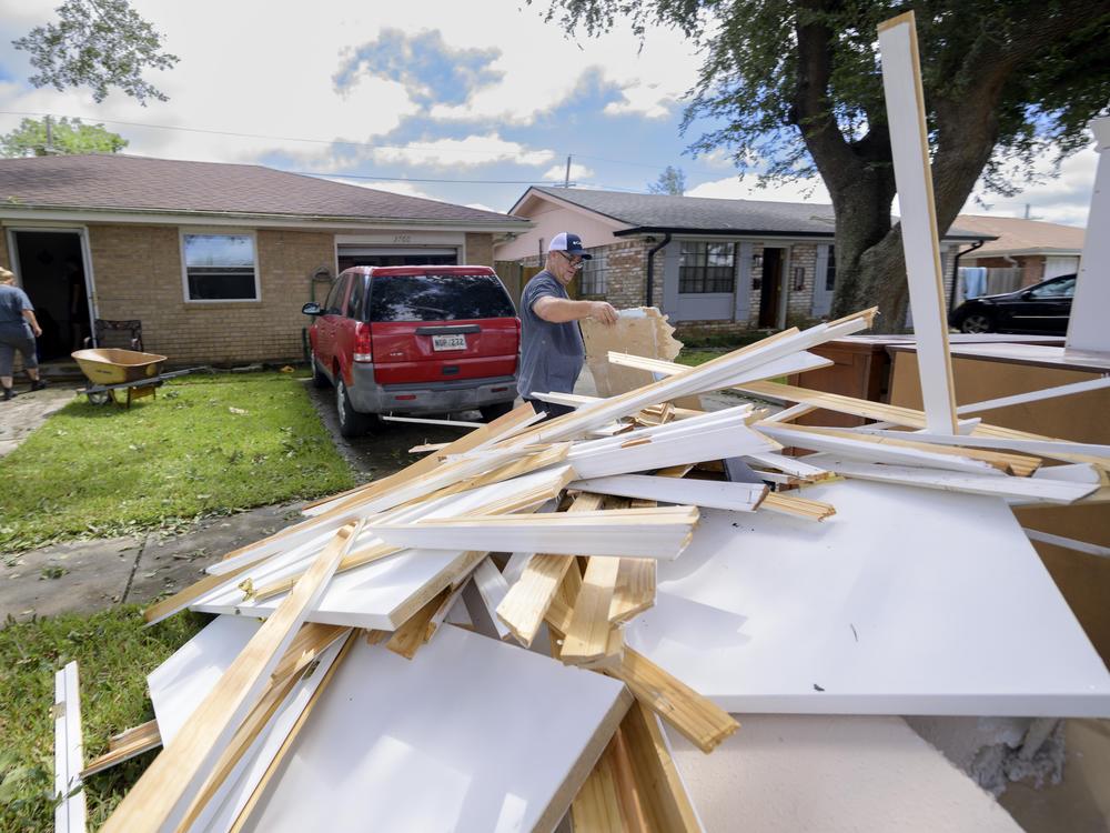In the aftermath of Hurricane Francine on Sept. 12 in Kenner, La., Shawn Murphy removes drywall at a friend's house after floodwater came up a few inches in the house, making most of the walls, floors and doors wet.