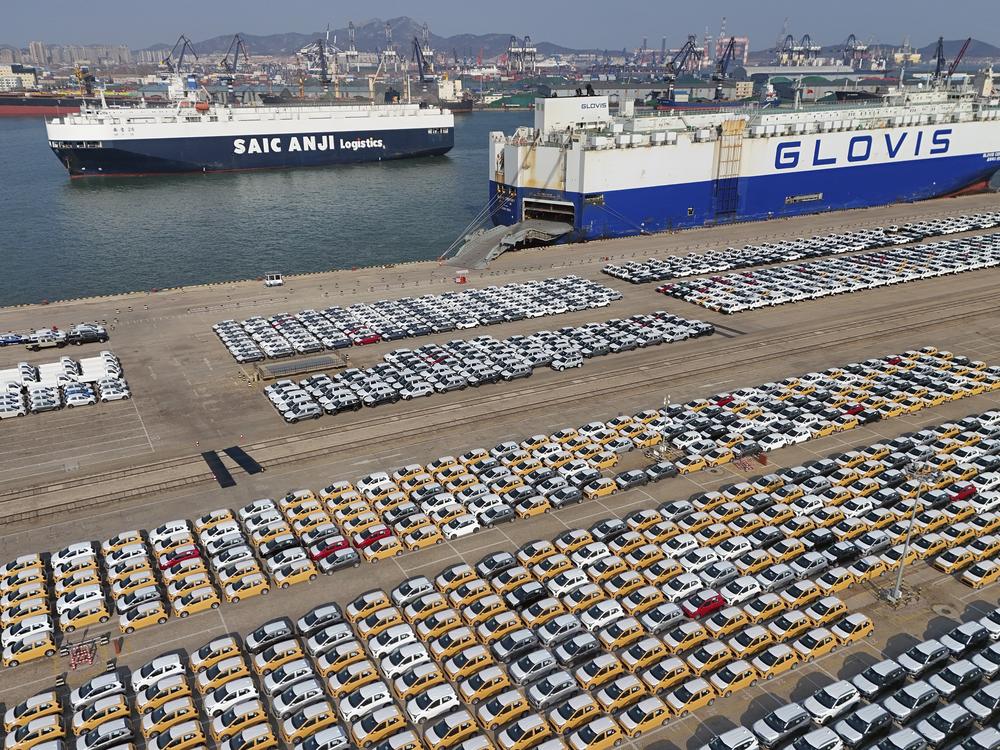Vehicles and trucks for export wait for transportation from a port in Yantai in eastern China's Shandong province on Jan. 2, 2025.