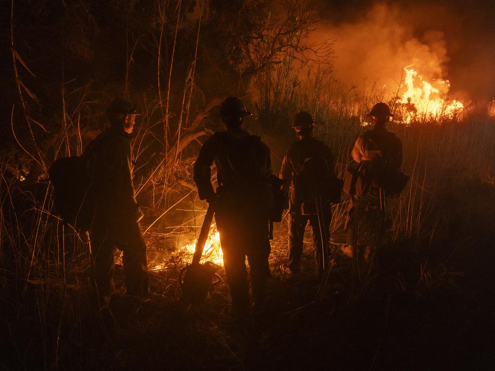 Firefighters monitor and control the spread of the Auto Fire in Oxnard, Calif., northwest of Los Angeles on Jan. 13, 2025.