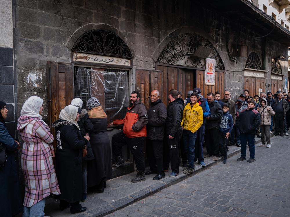 Syrians wait at a breadline at a bakery in the Syrian capital Damascus as the government faces a serious challenge: providing cheap bread. Men and women tend to queue up in separate lines so they don't bump into each other.
