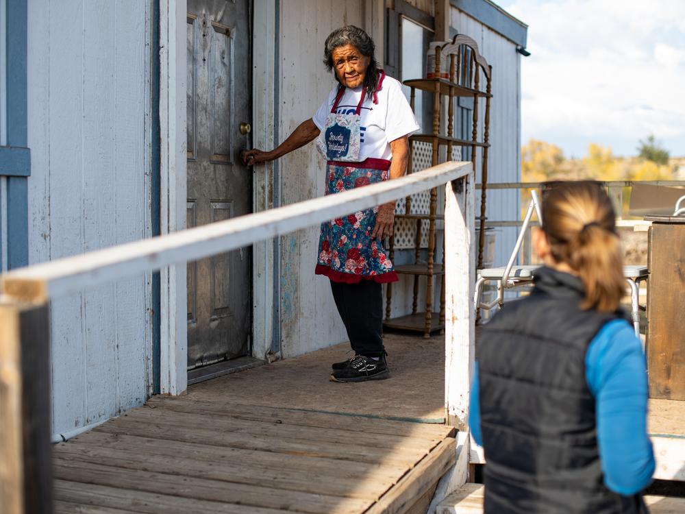 Entomologist Maureen Brophy, right, speaks to Lucille Felan, a resident of the San Carlos Apache Reservation, Ariz., about setting tick traps under her porch.