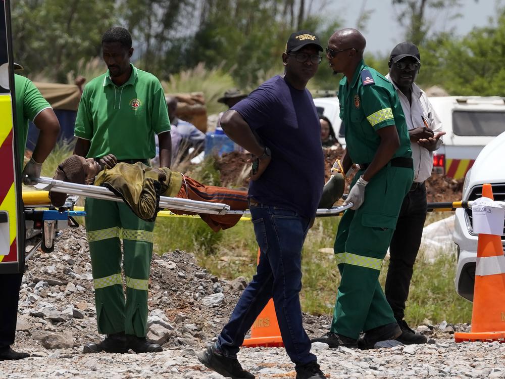 A miner is transported on a stretcher by rescue workers after he was rescued from below ground in an abandoned gold mine in Stilfontein, South Africa on Tuesday.