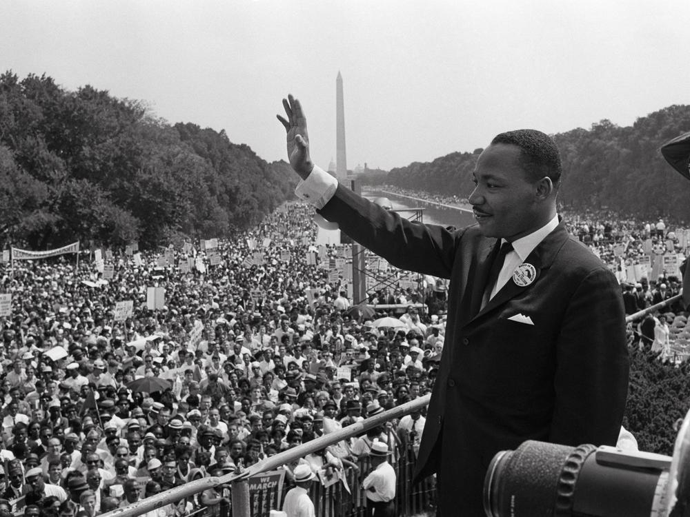 Martin Luther King waves to supporters on August 28, 1963 on the Mall in Washington, D.C., during the March on Washington for Jobs and freedom, where King delivered his famous 