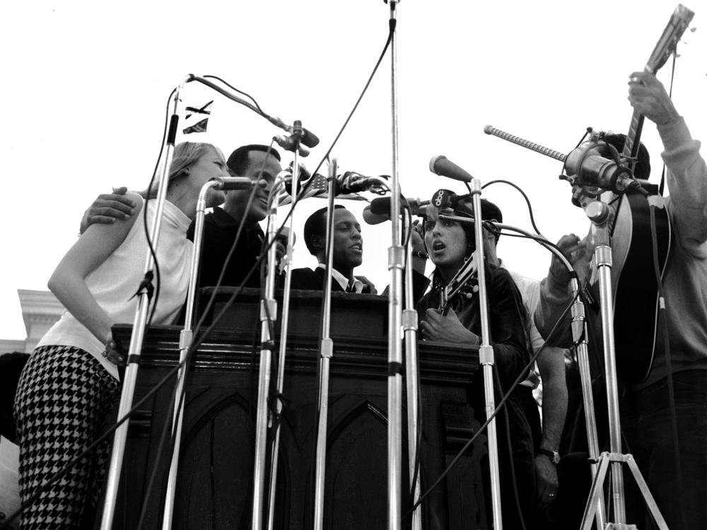 Musicians perform before 25,000 civil rights marchers in Montgomery, Ala. following a speech by Martin Luther King Jr. on March 25, 1965. Performers (from left to right) include Mary Travers, Harry Belafonte, Leon Bibb, Joan Baez and Oscar Brand.