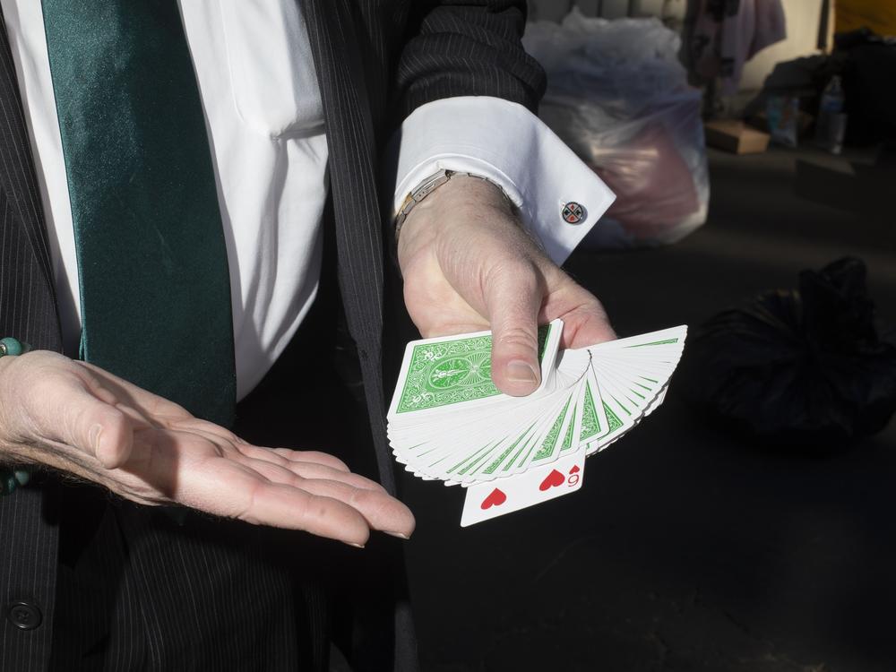 Close-up magician Paul Green displays a deck of playing cards.