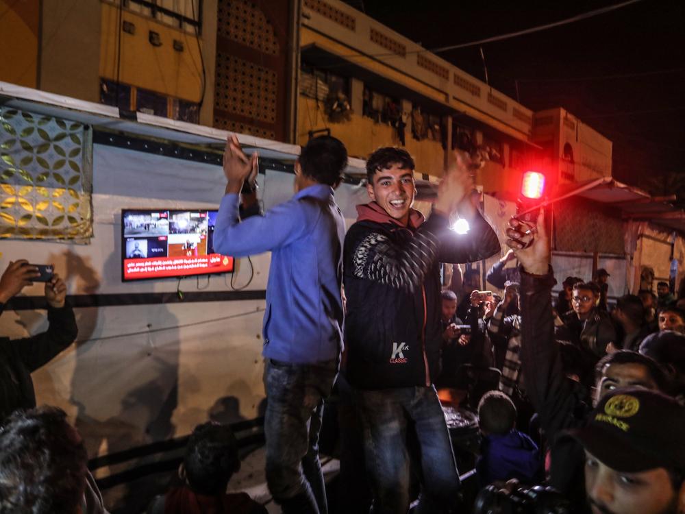 Palestinians celebrate in the southern Gaza city of Khan Younis after U.S. President-elect Donald Trump's announcement of hostage deal between Israel and Hamas on Wednesday.