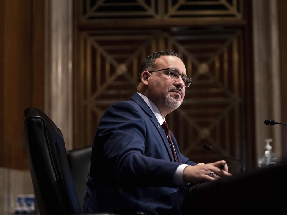 Miguel Cardona listens during his Capitol Hill confirmation hearing February 2021.<br>