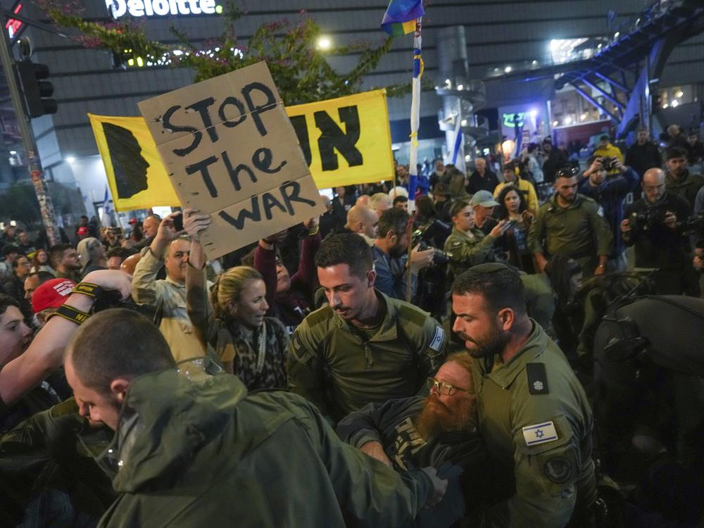 Police scuffle with demonstrators who block a road during a protest demanding a ceasefire deal and the immediate release of hostages held in the Gaza Strip by Hamas, in Tel Aviv, Israel, on Saturday.