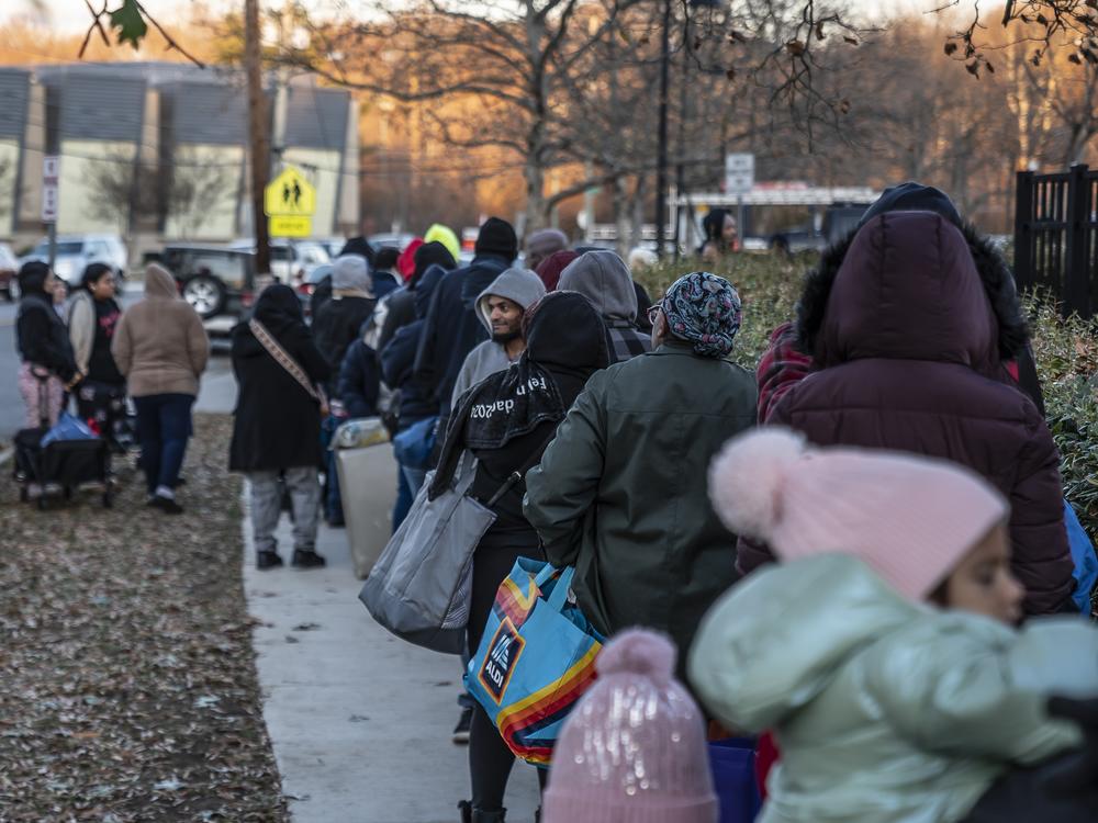 The pantry waiting line includes families. One woman said she was getting food for her homebound mother, and another was there for a neighbor with cancer.