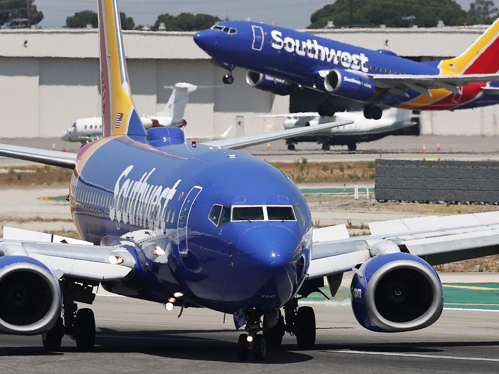 A Southwest Airlines plane takes off as another Southwest jet taxis in Burbank, Calif. Southwest Airlines has announced it will discontinue its 50-year policy of open seating, instead opting for assigned seating that will include premium seating in an effort to broaden its appeal.