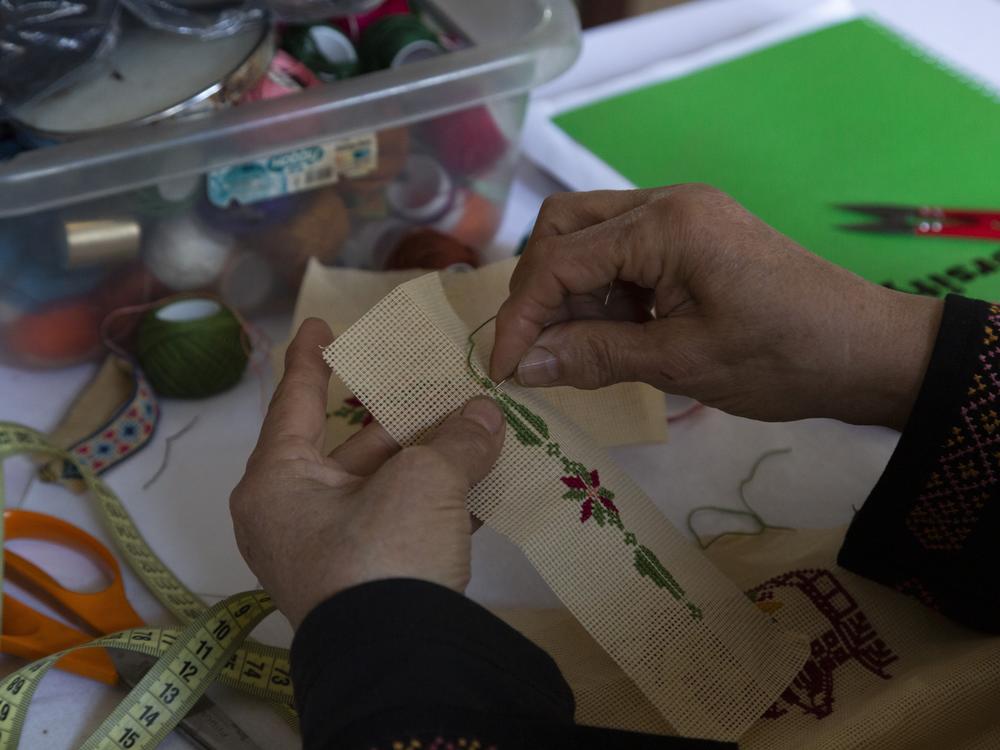 Hanan Zarura designs a tatreez pattern in her workshop in the Shatila refugee camp in Beirut, Lebanon. Every Palestinian region has its own unique embroidery design, and Zarura — who has never been anywhere in the Palestinian Territories — nevertheless knows them all.