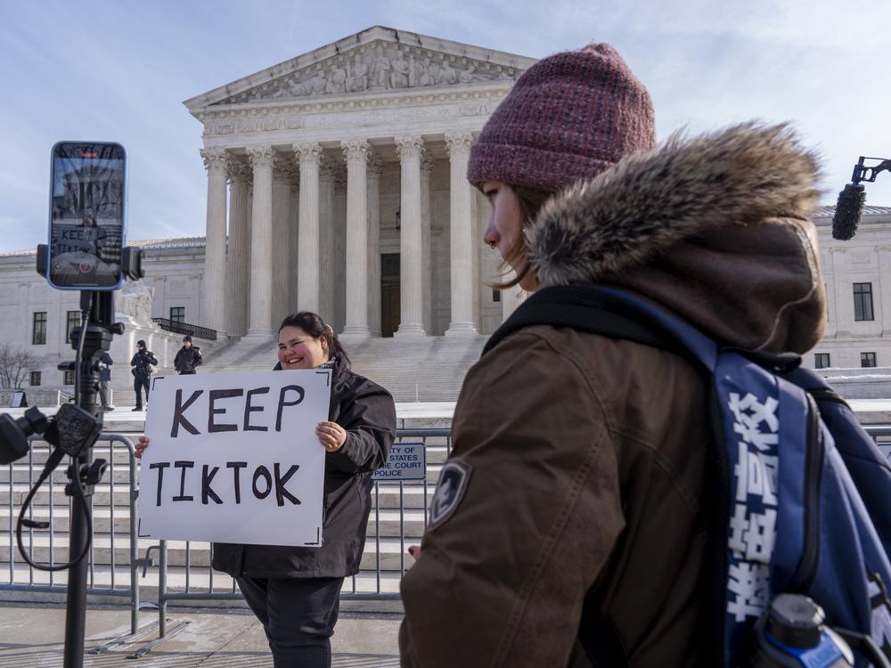 Callie Goodwin of Columbia, S.C., holds a sign in support of TikTok outside the Supreme Court on Jan. 10 in Washington, D.C. Goodwin, a small-business owner who sells personalized greeting cards, says 80% of her sales come from people who found her on TikTok.
