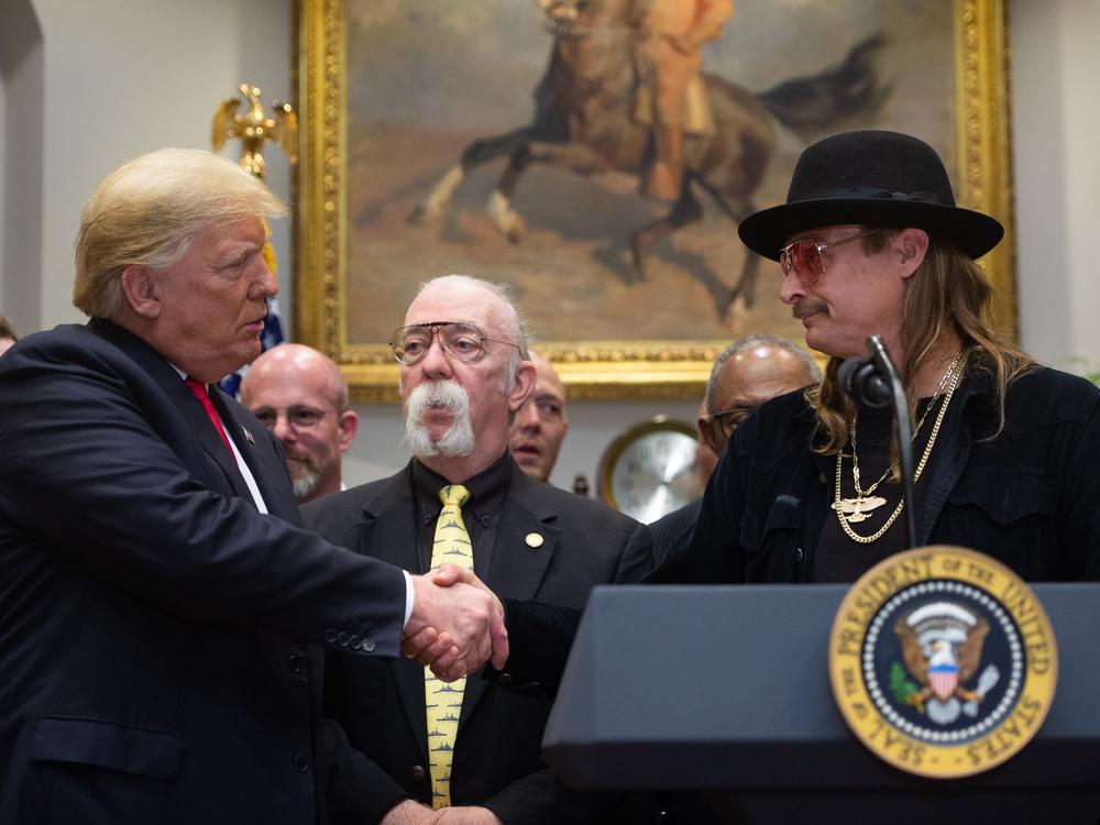 Kid Rock (right) shakes hands with President Trump after signing the Music Modernization Act in 2018.