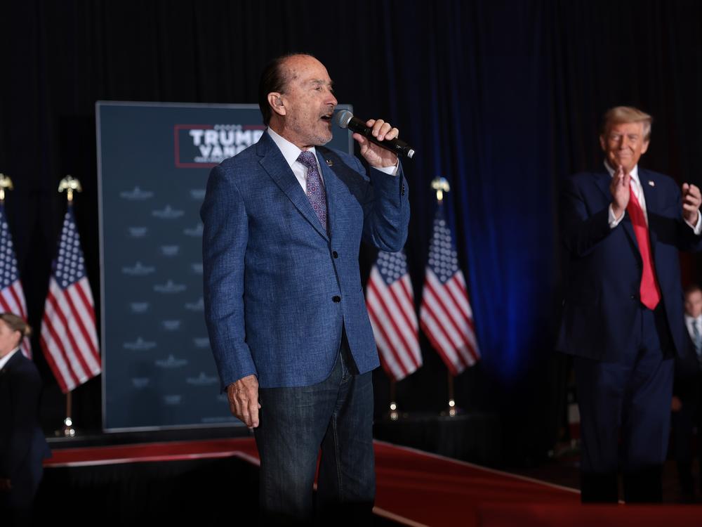 Lee Greenwood sings alongside President Trump during the 11th Hour Family Leaders Meeting at the Concord Convention Center in Concord, North Carolina.