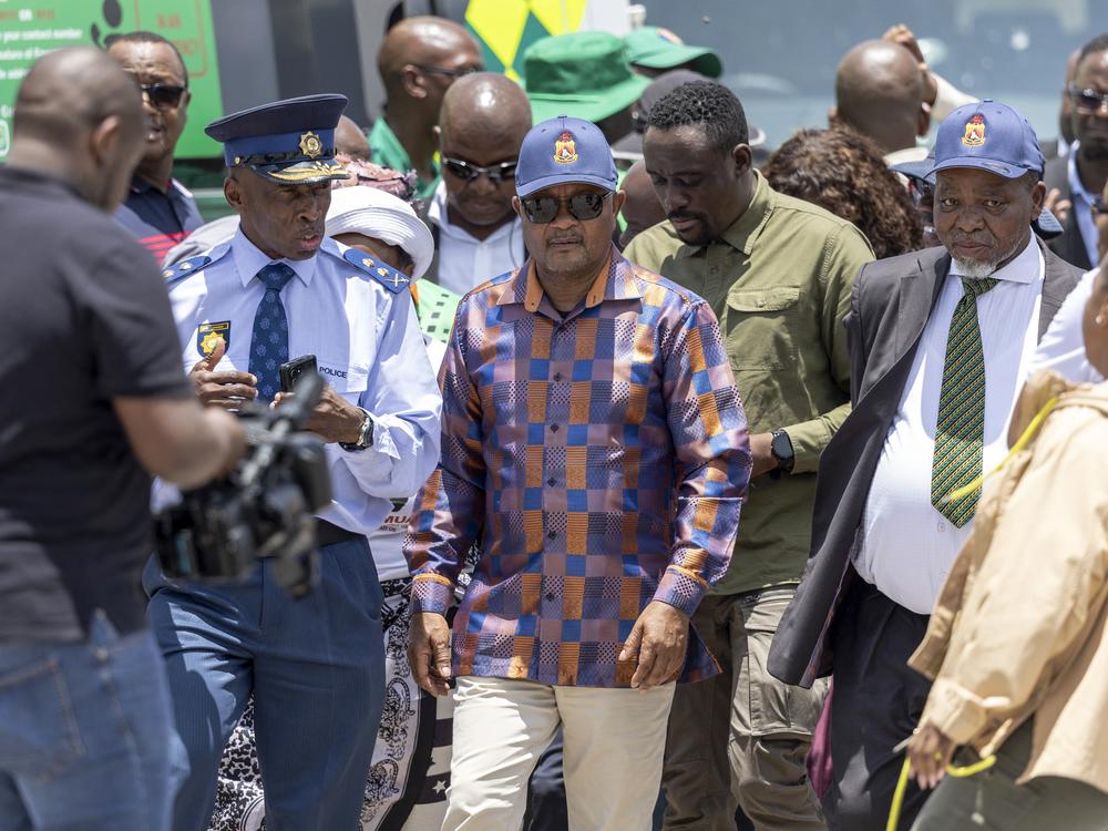 South African Minister of Police Senzo Mchunu and South African Minister of Mineral Resources Gwede Mantashe (R) inspect the site alongside senior members of the South African Police Service (SAPS) during the rescue operation to retrieve illegal miners from an abandoned gold mine in Stilfontein on January 14, 2025.