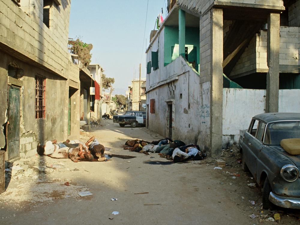 This 1982 archive image from inside the Shatila refugee camp shows the bodies of Palestinian refugees killed by Christian Lebanese militia fighters allied with Israel. Hanan Zarura survived the massacre, but her father-in-law was killed.