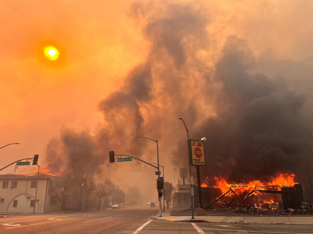 Flames from the wind-driven Eaton Fire engulf a house in Altadena, Calif., on Jan. 8, 2025.