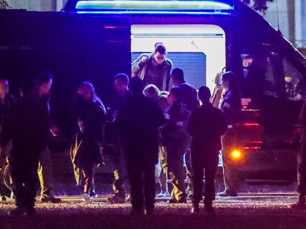 The three released Israeli hostages, who had been abducted during the Oct. 7, 2023, attacks by Palestinian militants, exit a van before boarding an Israeli Air Force military transport helicopter near Reim in southern Israel on Jan. 19 as part of a ceasefire deal.