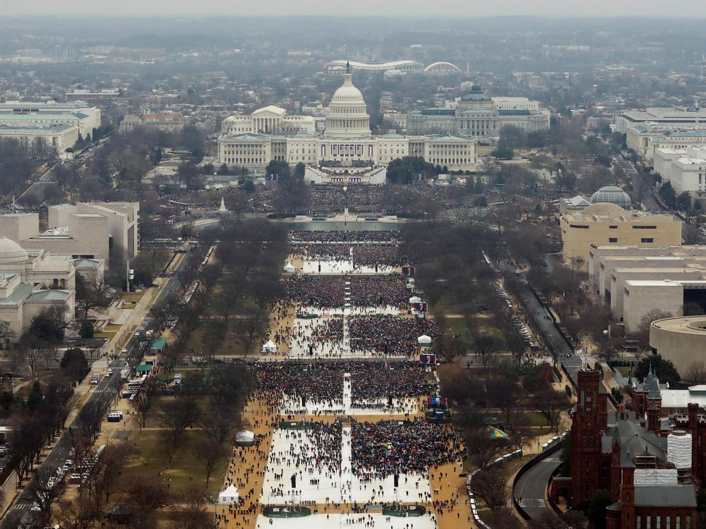Attendees line the Mall as they watch ceremonies to swear in Donald Trump on Inauguration Day on Jan. 20, 2017, in Washington, D.C.