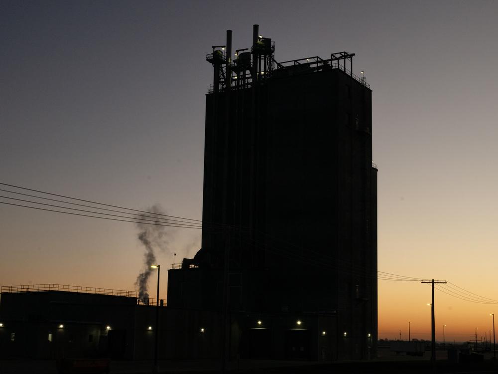 A factory plant billows smoke in the early hours of the morning in Fremont, Neb.