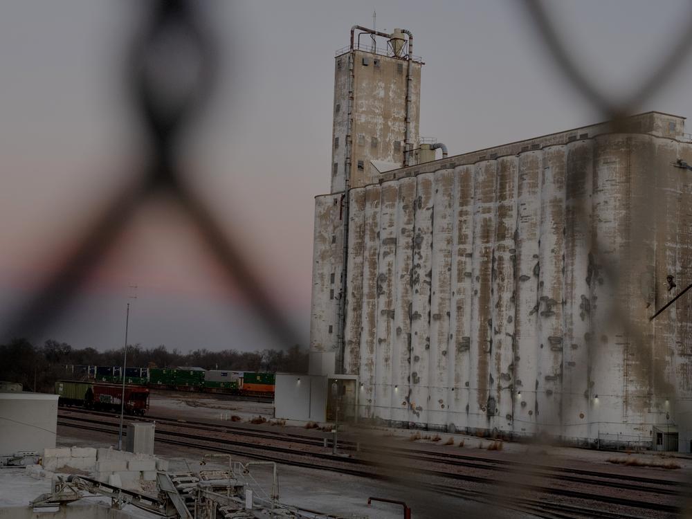 A factory plant sits next to a bridge toward downtown in Fremont, Neb.