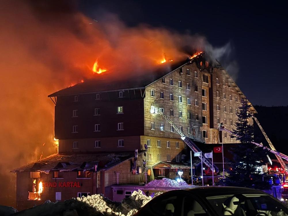 Firefighters work to extinguish a fire in a hotel at a ski resort of Kartalkaya in Bolu province, in northwest Turkey, on Tuesday.