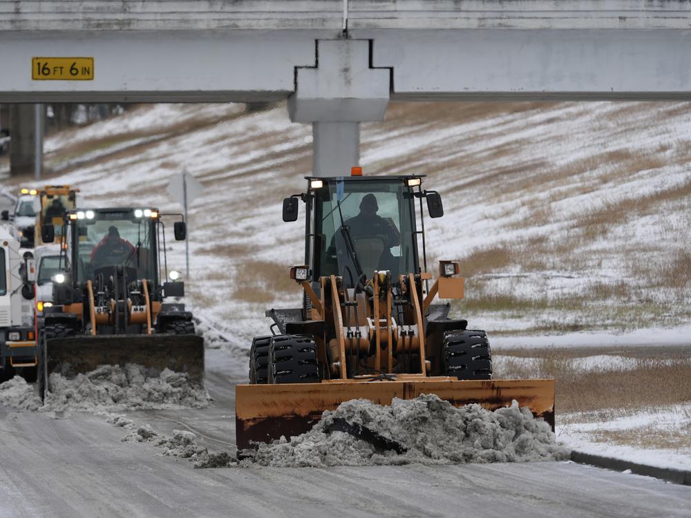 Houston, Texas: Workers plow snow off the roadways at the closed George Bush Intercontinental Airport on Jan. 21.