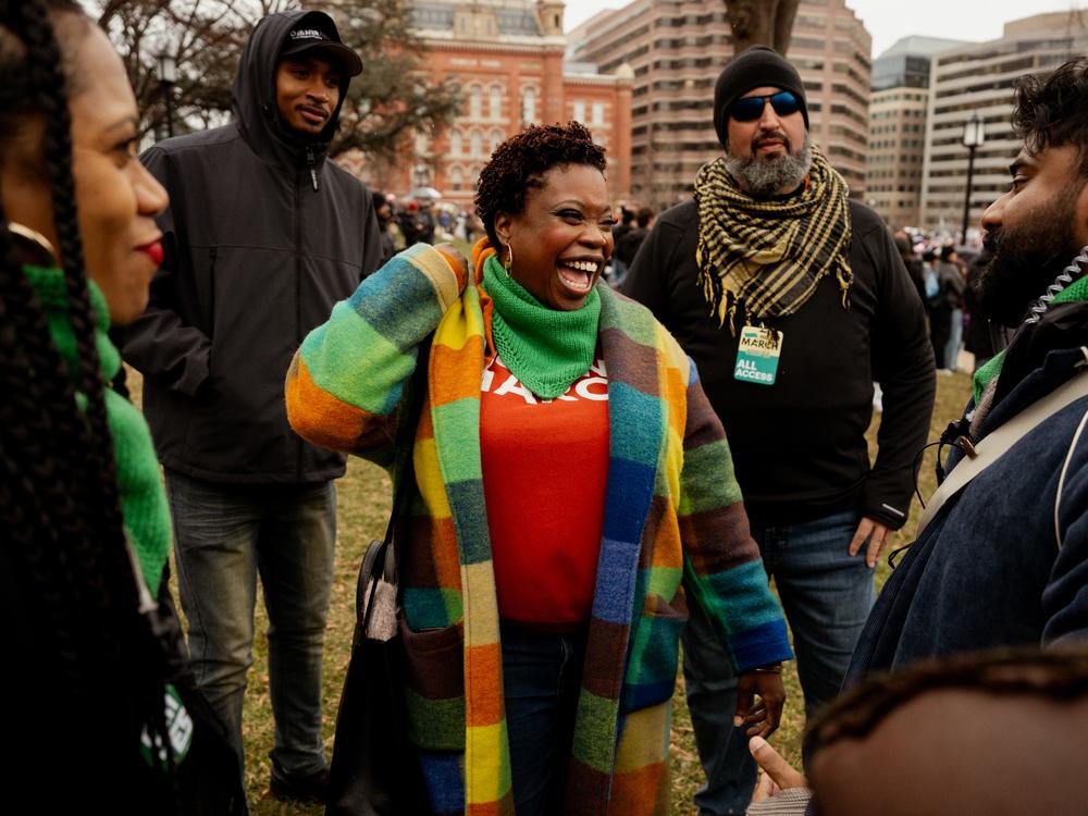 Tamika Middleton, managing director for the Women's March, center, reacts while talking to staff during the People's March on Jan. 18, in Washington D.C.