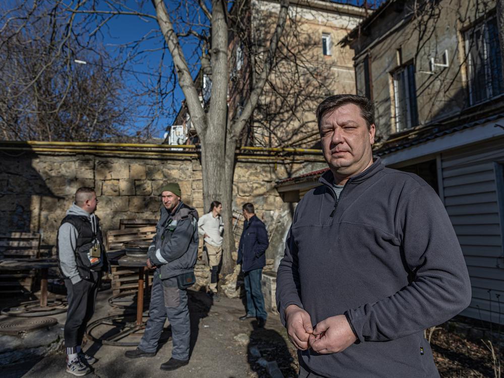 Danil Tatarinov, head of a civilian internet company in Kherson, with other company staff in the backyard of the company office. Despite what he says is the 