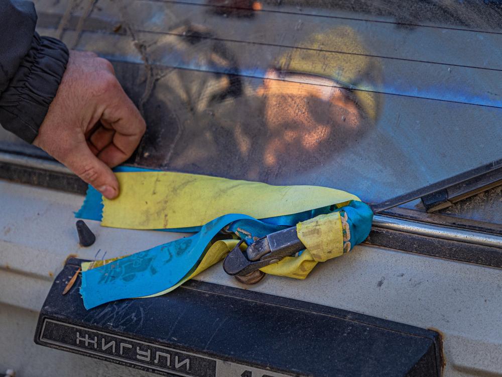 Ukrainian flag stripes on Danil Tatarinov's civilian car, which he says was damaged by a Russian drone strike.