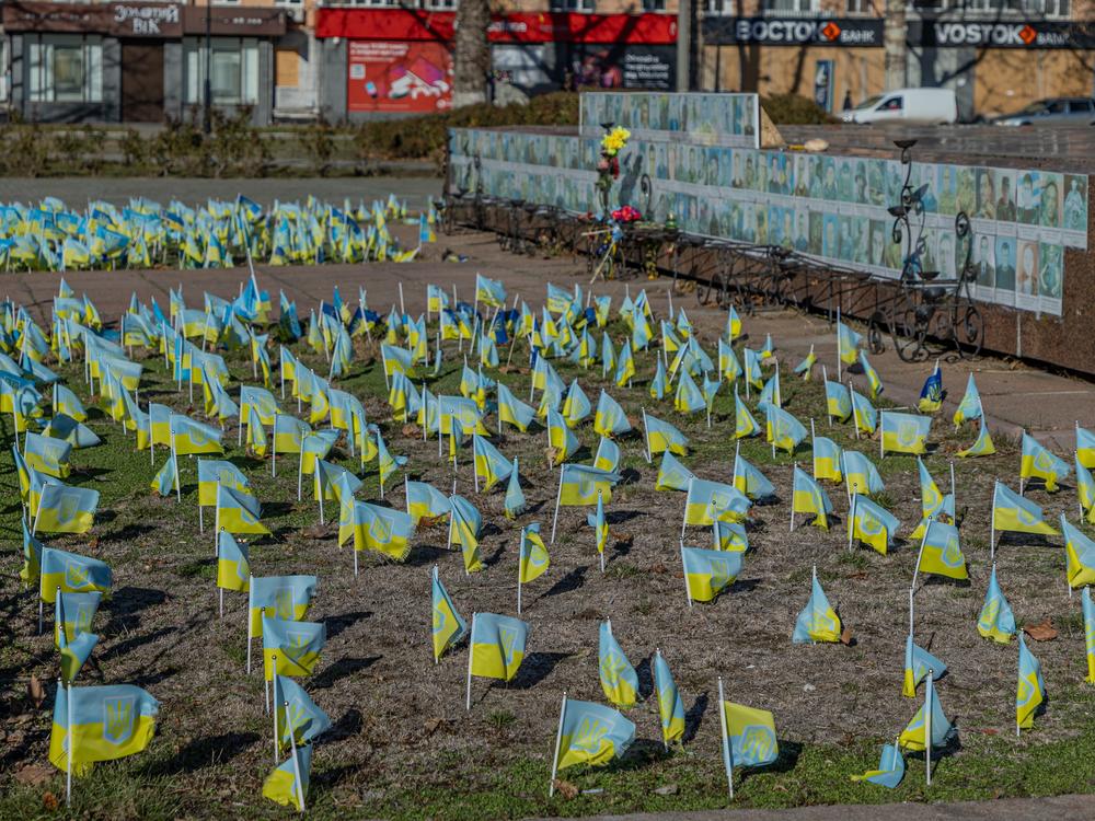Ukrainian flags honor the names of fallen Ukrainian soldiers in front of Kherson's regional city administration building.
