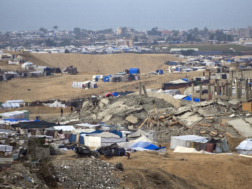 A tent camp for displaced Palestinians stands amid destroyed buildings in the Khan Younis refugee camp, in the southern Gaza Strip, on Jan. 4.