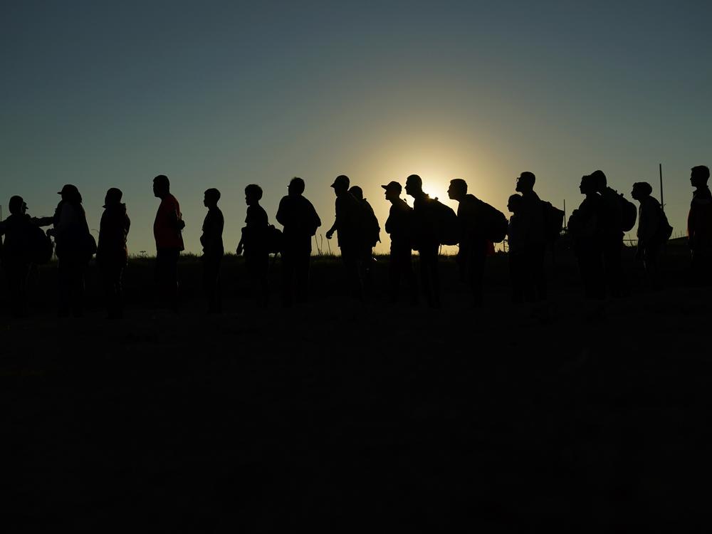 Migrants who crossed the Rio Grande and entered the U.S. from Mexico are lined up for processing by U.S. Customs and Border Protection on Sept. 23, 2023, in Eagle Pass, Texas.