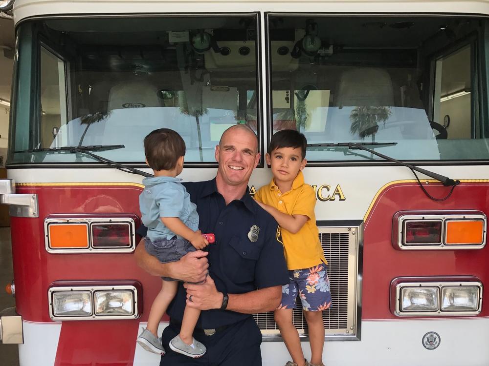 <em>Old photo of fire captain Shane Lawlor and his two sons at a Santa Monica Fire Station. Lawlor has been a firefighter for 17 years. He was dispatched last week to the Pacific Palisades and is still fighting the fires there.</em>